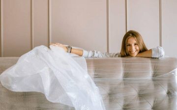 woman unwrapping new sofa