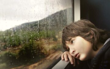 boy looking in the window traveling