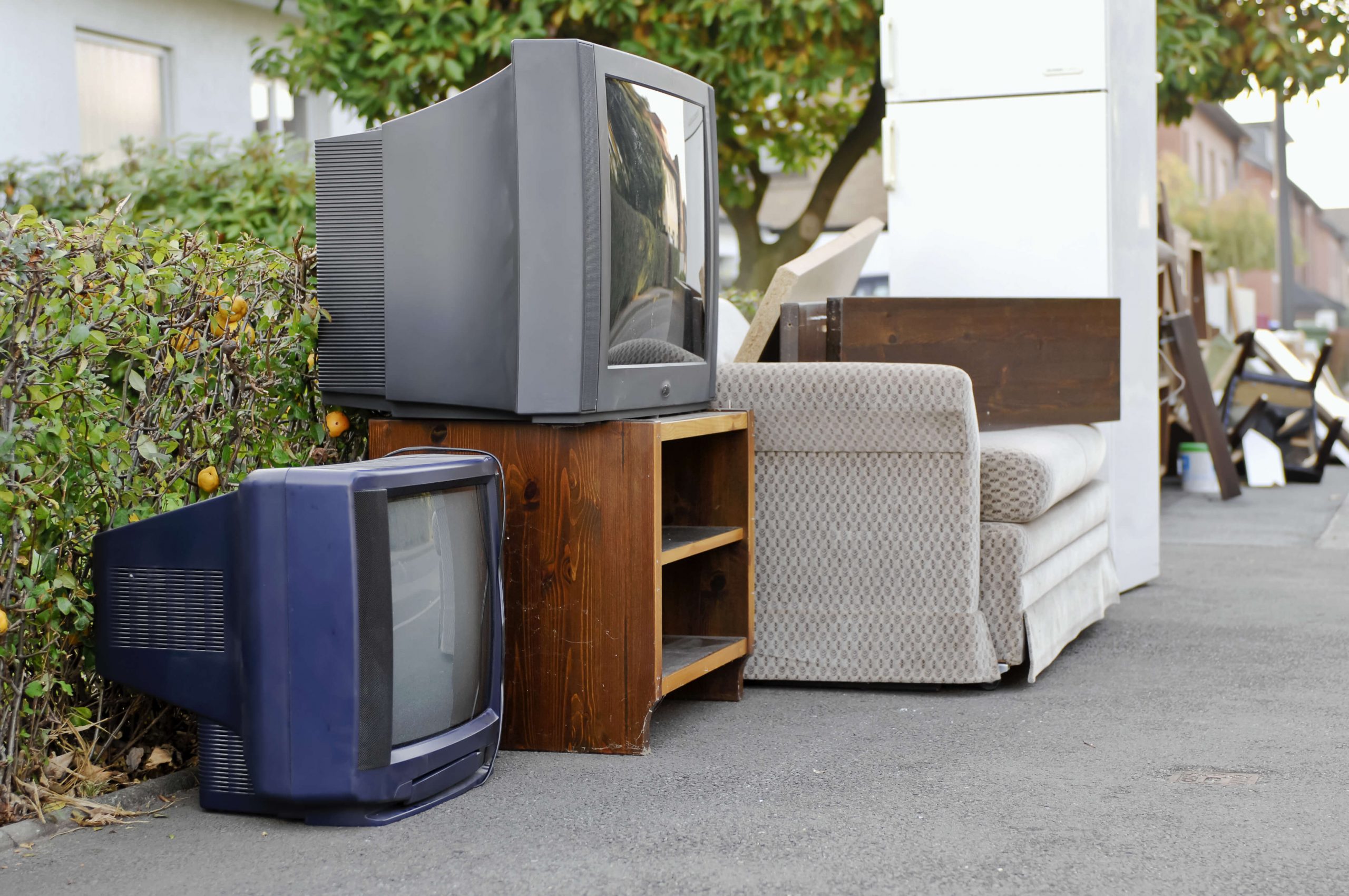 TVs, TV stand, and sofa out on curb
