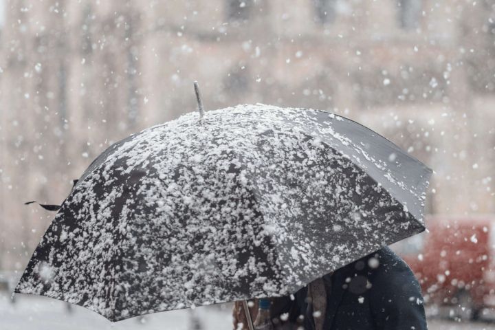 woman holding umbrella with snow