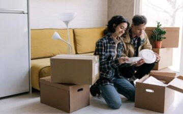 couple taking dishes out of moving boxes