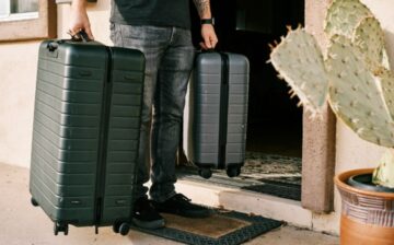 student bringing suitcases to new apartment