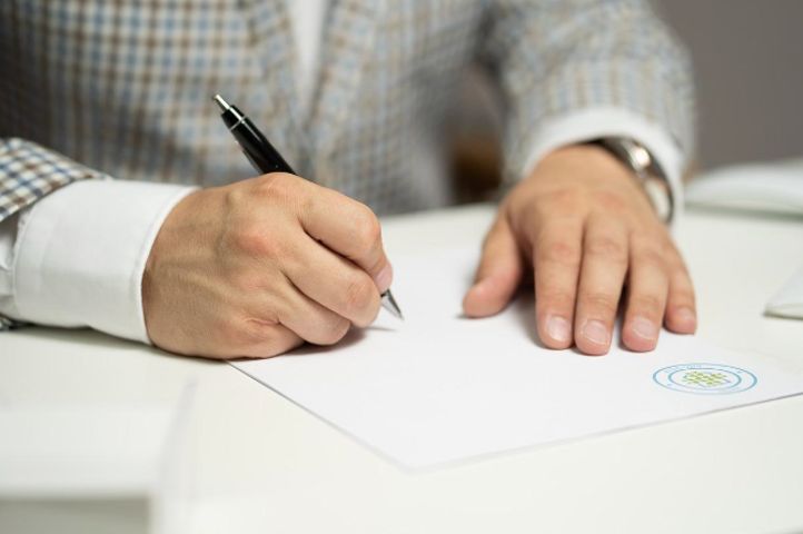 man signing contract for the comfort of his home