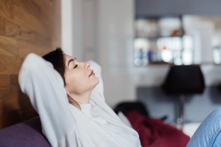 Woman breathing good quality air at home