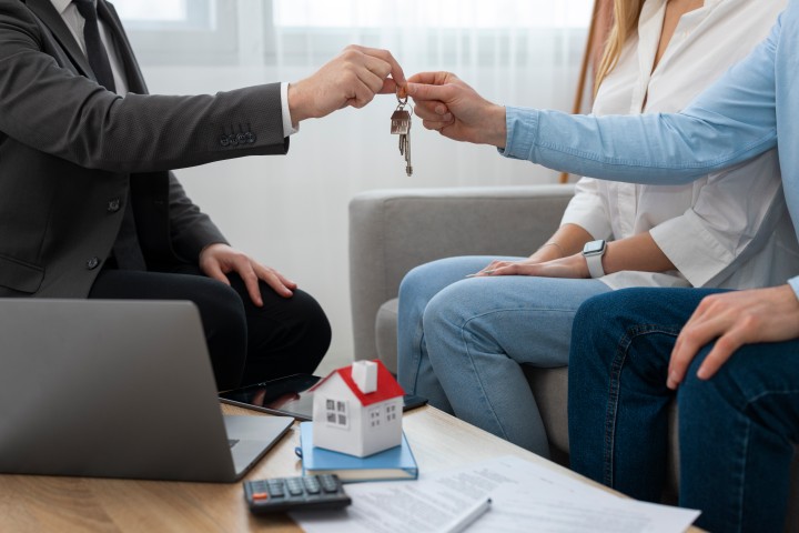 couple grabbing the keys to their new house