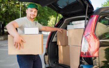 man loading moving boxes into the car