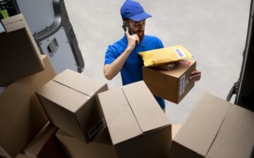 man talking on the phone with package for shipping