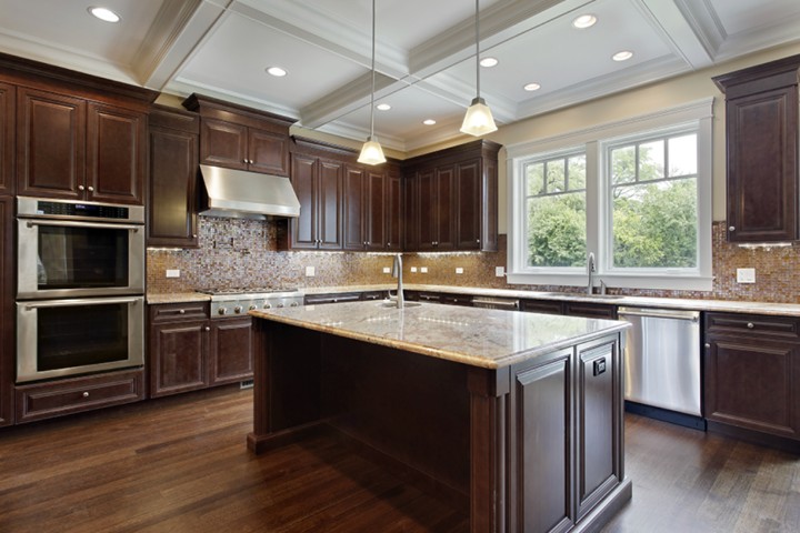 remodeled kitchen with island many cabinets in wood color