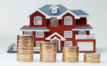 Miniature house with coins