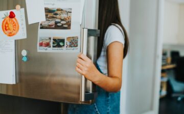 Woman opening the freezer that she is going to prepare for the move