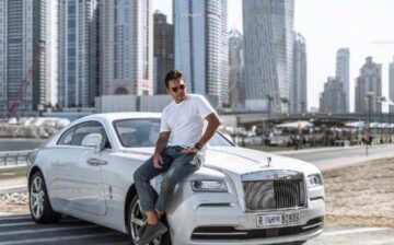 man sitting in a car in dubai city