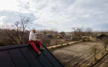 man sitting on the edge of the roof