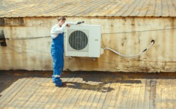 man working on replacing an air conditioner