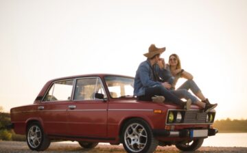 young couple sitting classic car