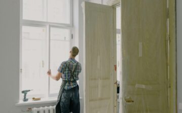 man placing window in room