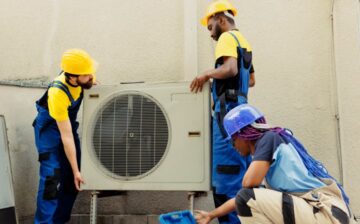 team replacing old air conditioner