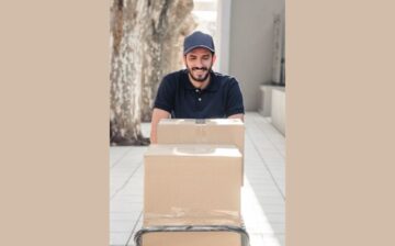 delivery smiling man with cardboard boxes