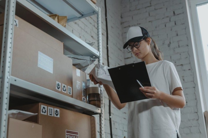 Woman checking inventory of her business