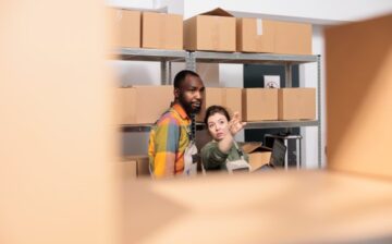 couple sorting boxes in the garage