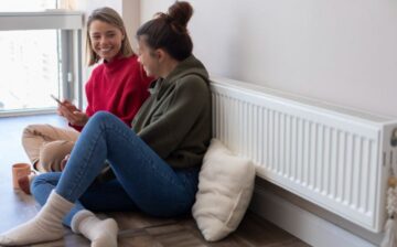 girls sitting next to boiler