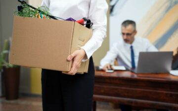 woman with moving box in office