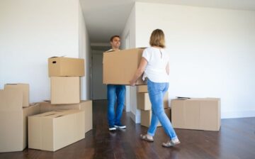 couple holding moving boxes