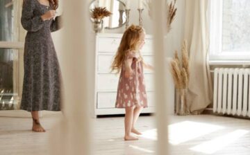 girl dancing at home with her mother