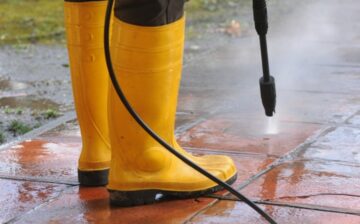 man cleaning with pressure washing