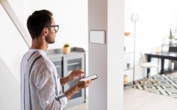 man using smartphone his automated home