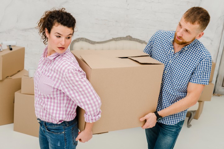 man woman carrying big box