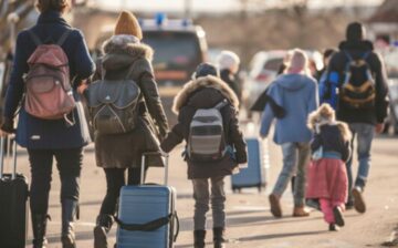 students walking with suitcase