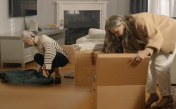 women packing moving boxes