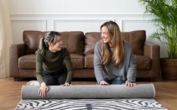 friends rolling up carpet