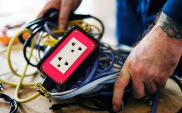 man with cables and plug