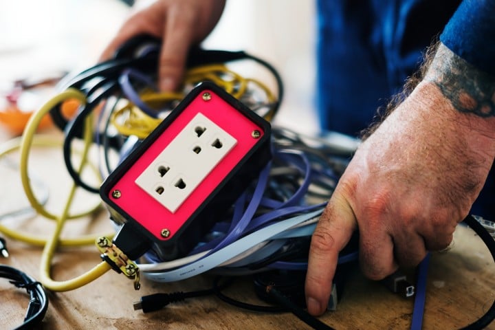 man with cables and plug