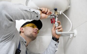 plumber fixing pipes in remodeling