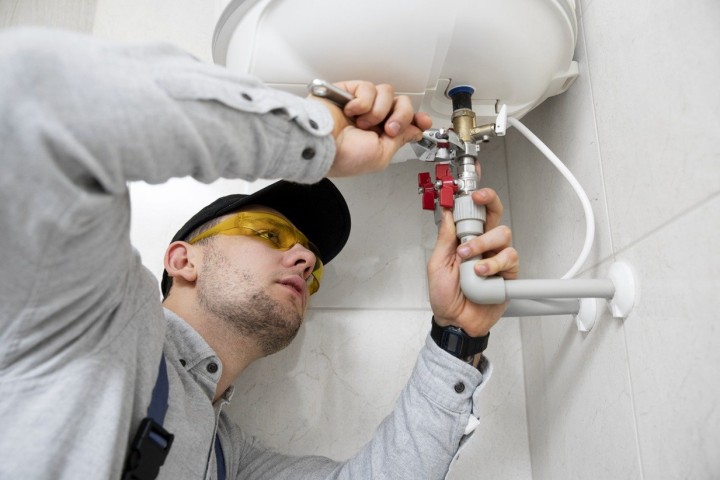 plumber fixing pipes in remodeling