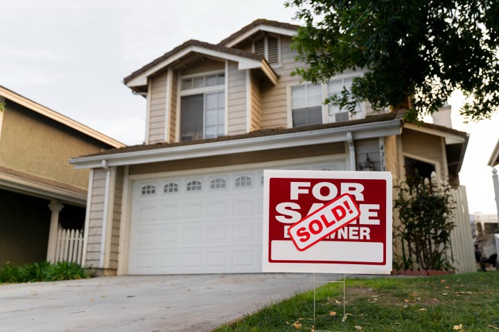 house with sold yard sign